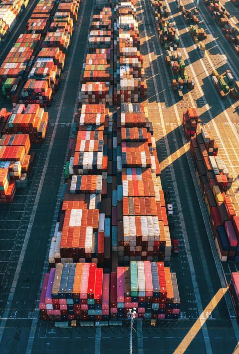 Aerial view of colourful shipping containers in a harbour.