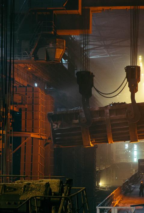Industrieunternehmen von innen, wo große Maschinen Metall transportieren.  