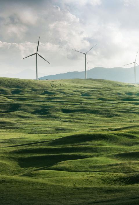green montainous landscape with wind turbines