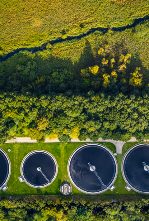 Sustainable water recycling sewage treatment plants shot from above within a green landscape