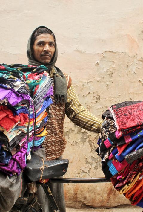 Indian vender selling clothes on a bicycle. 