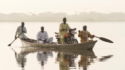 A boat taxi transports people and goods across the lake near Baga Sola, Chad