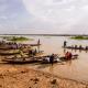 Men ferry people and goods on dugouts on Niger River near Niamey, Niger.