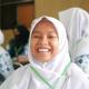 Indonesian school girl smiles into the camera. 
